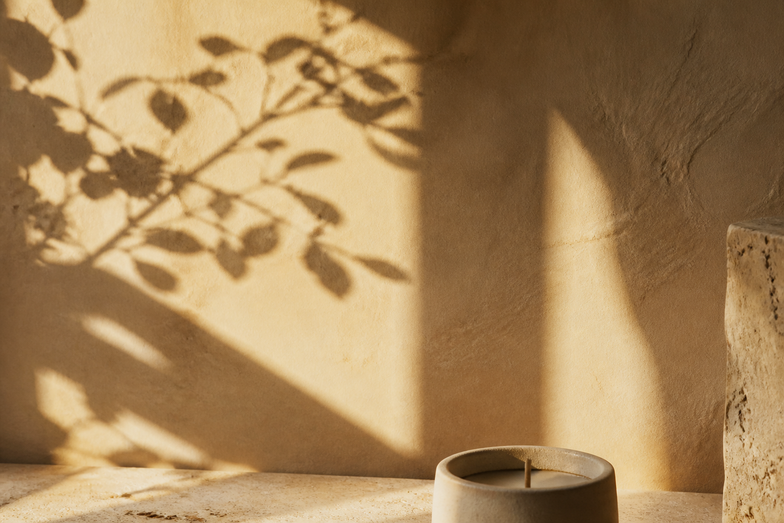Botanical shadows in a warm candle ritual setting